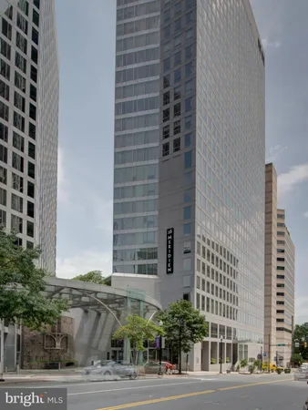 a view of a tall building next to a road