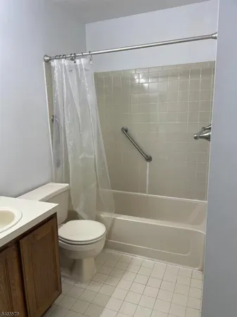 a bathroom with a shower a toilet and a sink