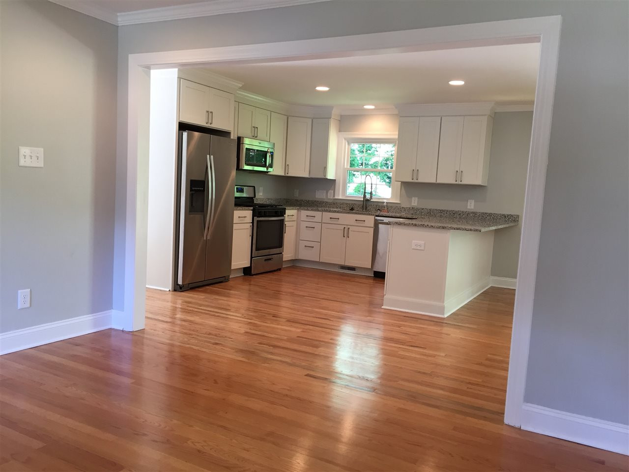 5721 Deblyn Avenue Raleigh, NC 27612 - Photo 12 of 12 Wide open floorplan showcasing casual modern living at its best! This is the view from the living room into the kitchen! Living Room