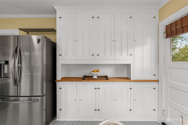 a kitchen with stainless steel appliances a refrigerator and a cabinets