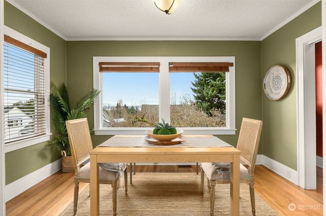 a dining room with furniture and window