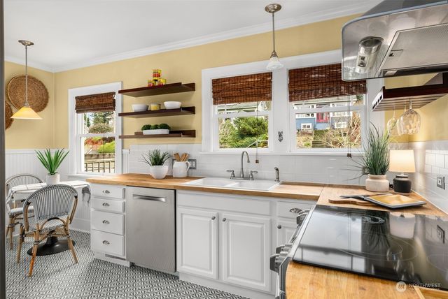 a kitchen with a sink stove and cabinets