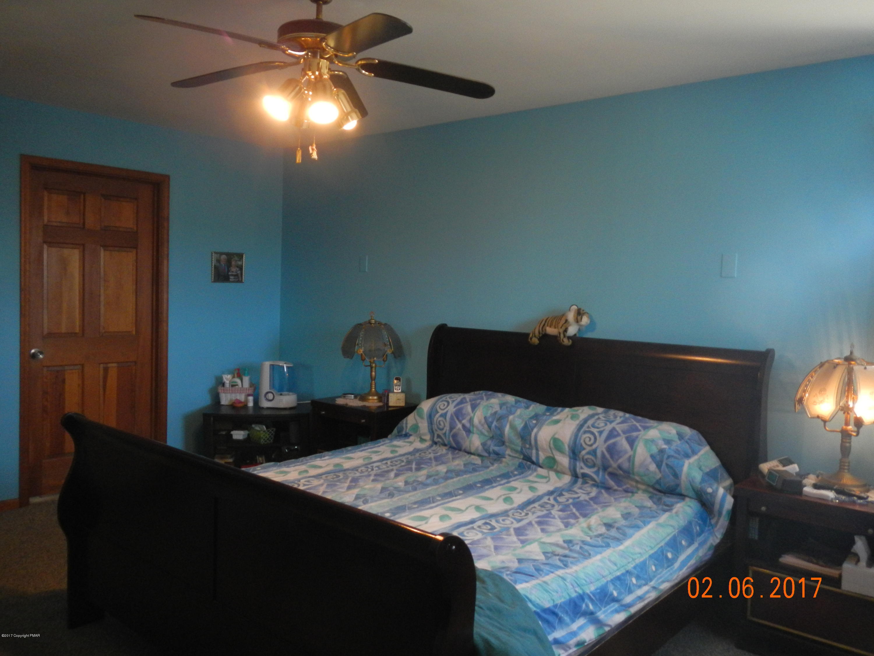 202 Rustic Road Kunkletown, PA 18058 - Photo 11 of 19 a bedroom with a bed and a lamp