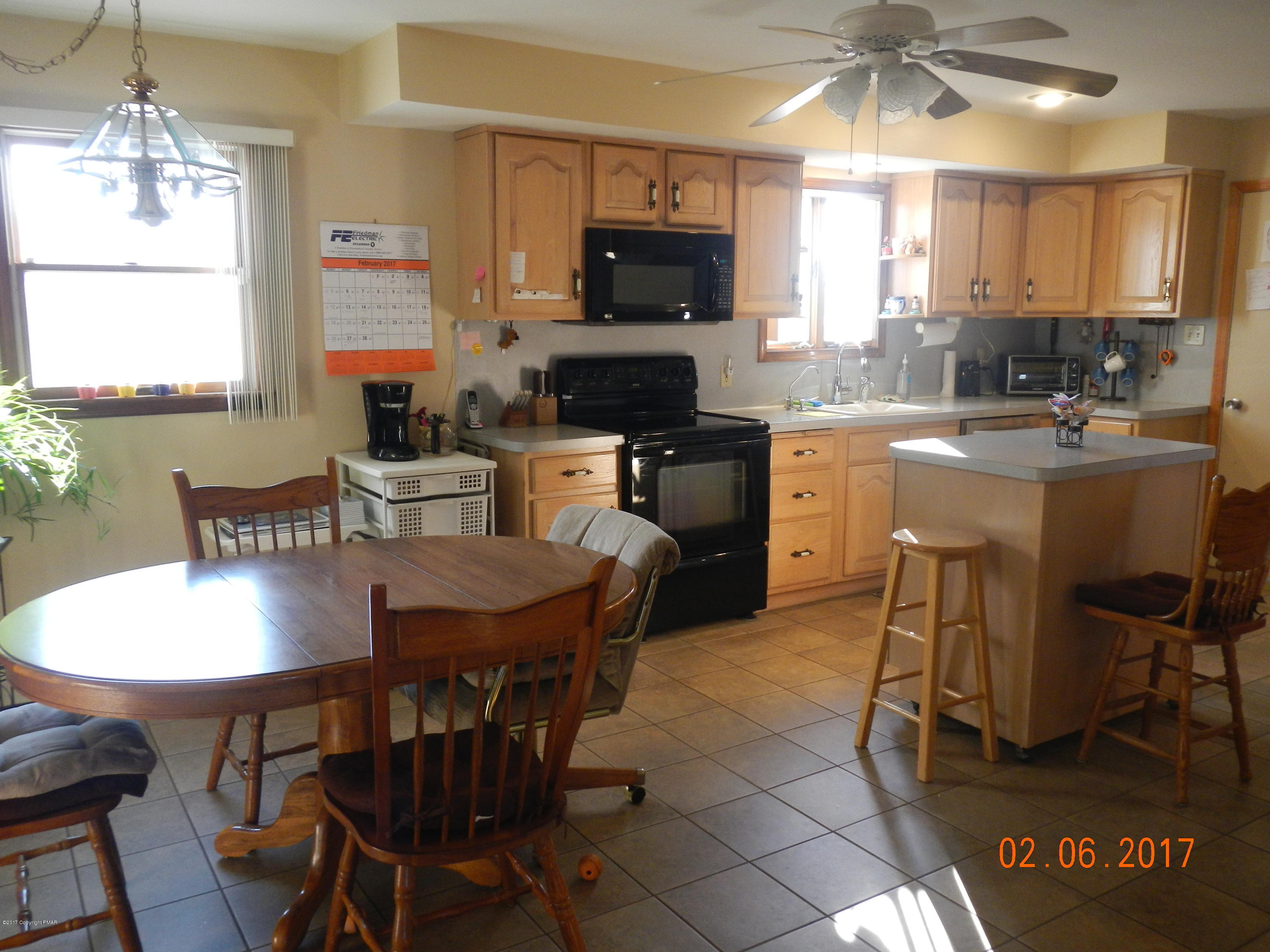 202 Rustic Road Kunkletown, PA 18058 - Photo 6 of 19 a kitchen with a dining table chairs and a refrigerator