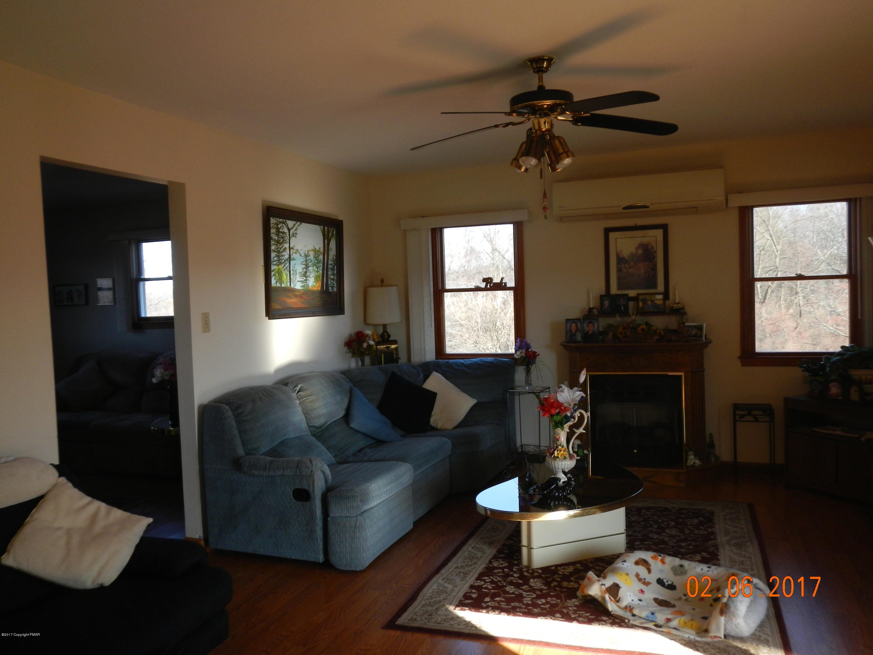 202 Rustic Road Kunkletown, PA 18058 - Photo 8 of 19 a living room with furniture a fireplace and a chandelier