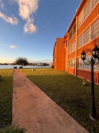 a view of an house with backyard and pool