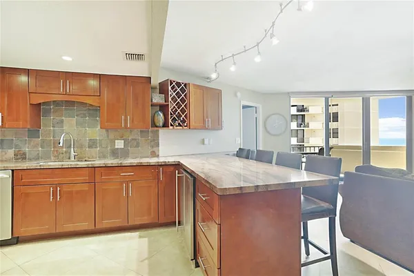 a kitchen with stainless steel appliances granite countertop a sink and cabinets