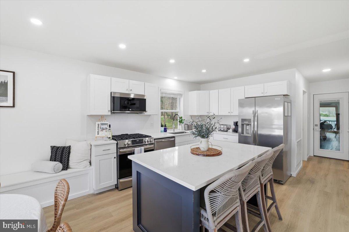 128 Lidio Road Blakeslee, PA 18610 - Photo 16 of 63 a kitchen with a sink a stove and chairs