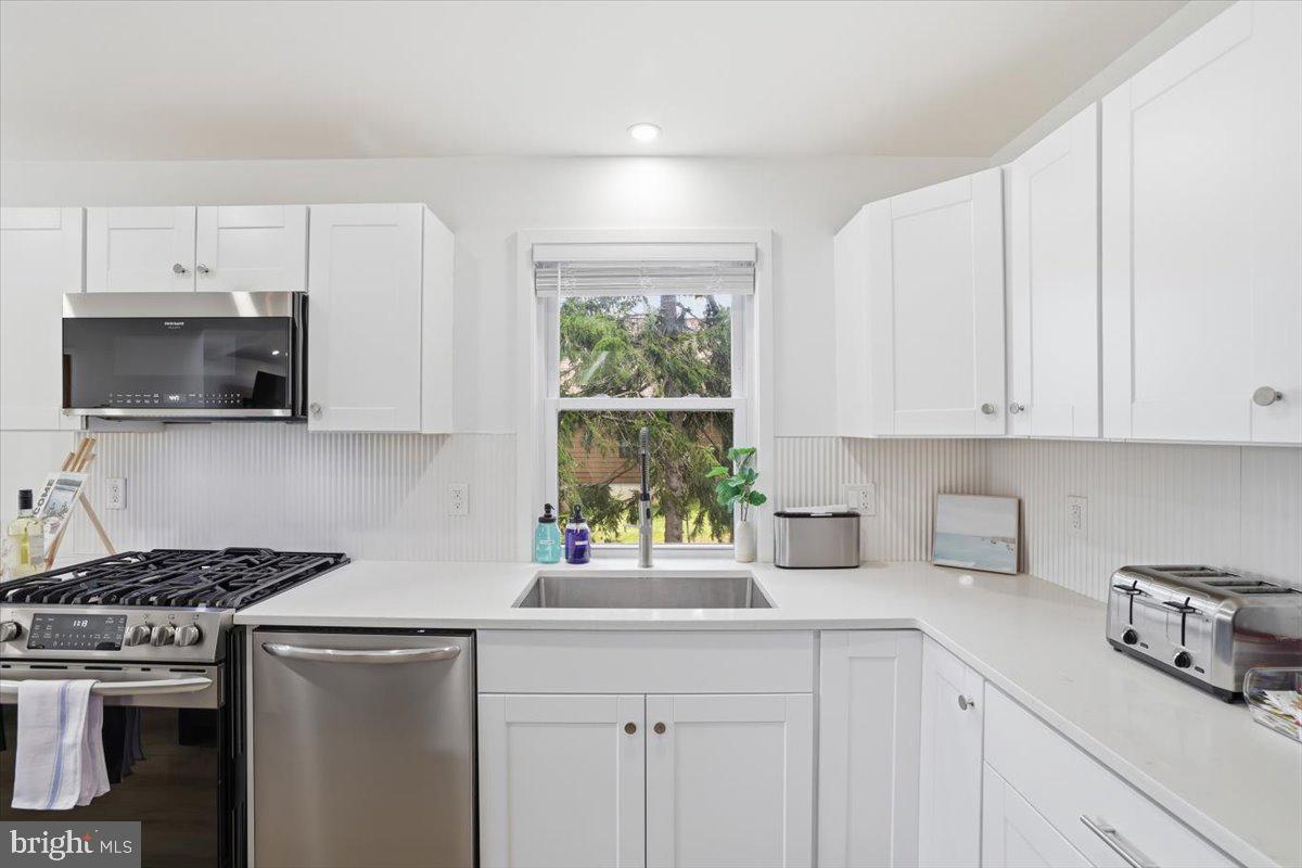 128 Lidio Road Blakeslee, PA 18610 - Photo 17 of 63 a kitchen with stainless steel appliances white cabinets and a stove top oven