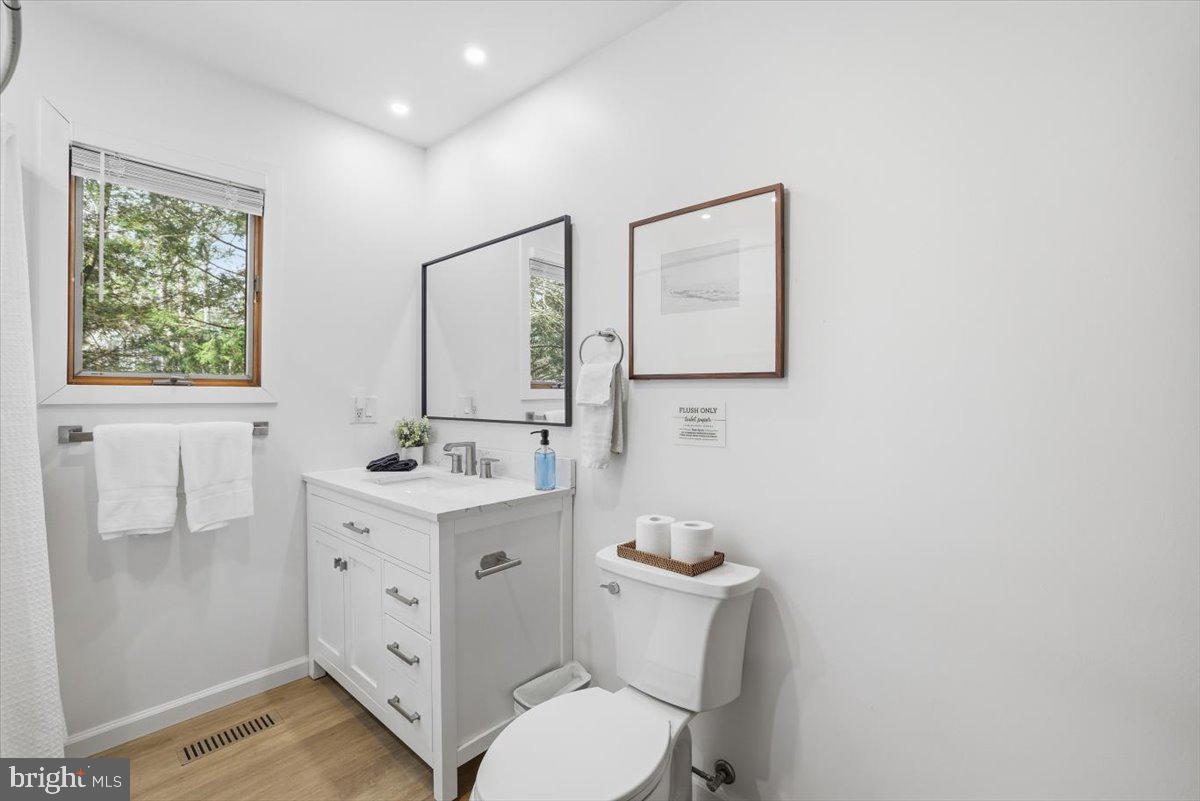128 Lidio Road Blakeslee, PA 18610 - Photo 27 of 63 a bathroom with a toilet a sink a vanity and mirror