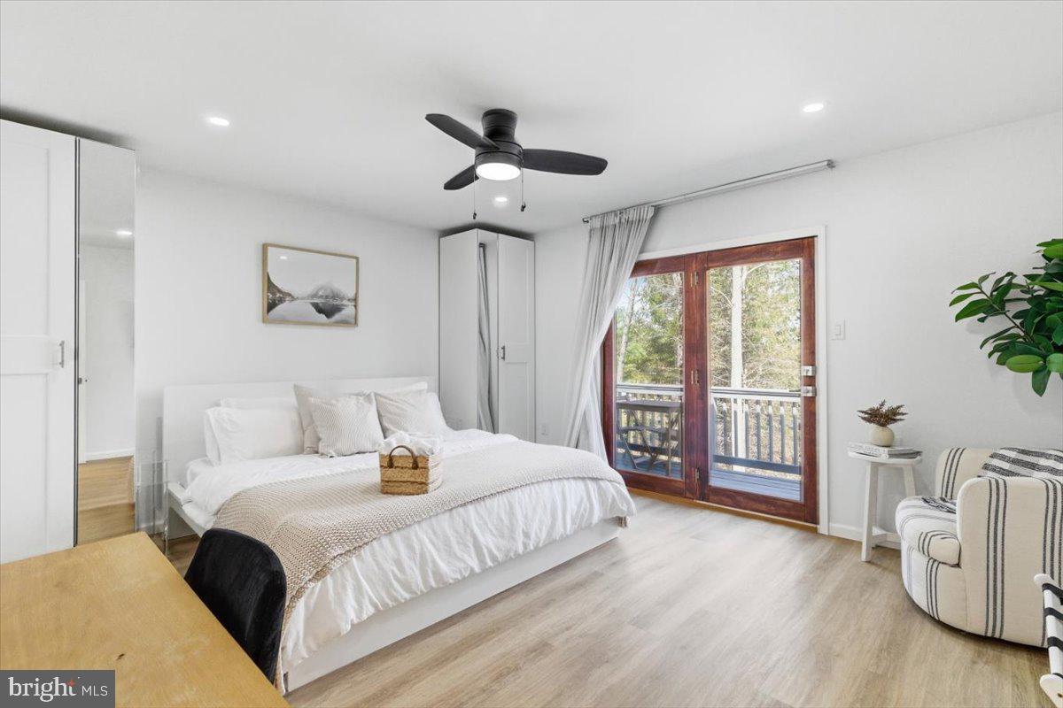 128 Lidio Road Blakeslee, PA 18610 - Photo 30 of 63 a bedroom with a large bed and a chandelier