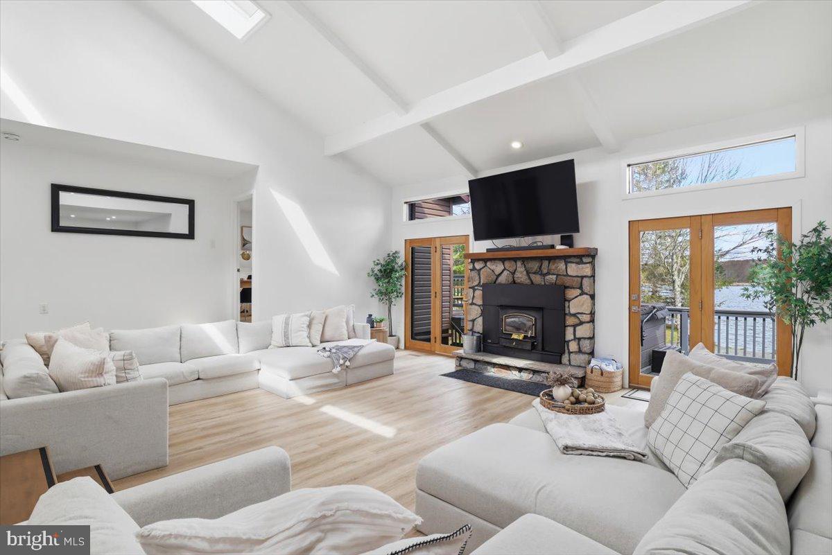 128 Lidio Road Blakeslee, PA 18610 - Photo 6 of 63 a living room with furniture a flat screen tv and a fireplace