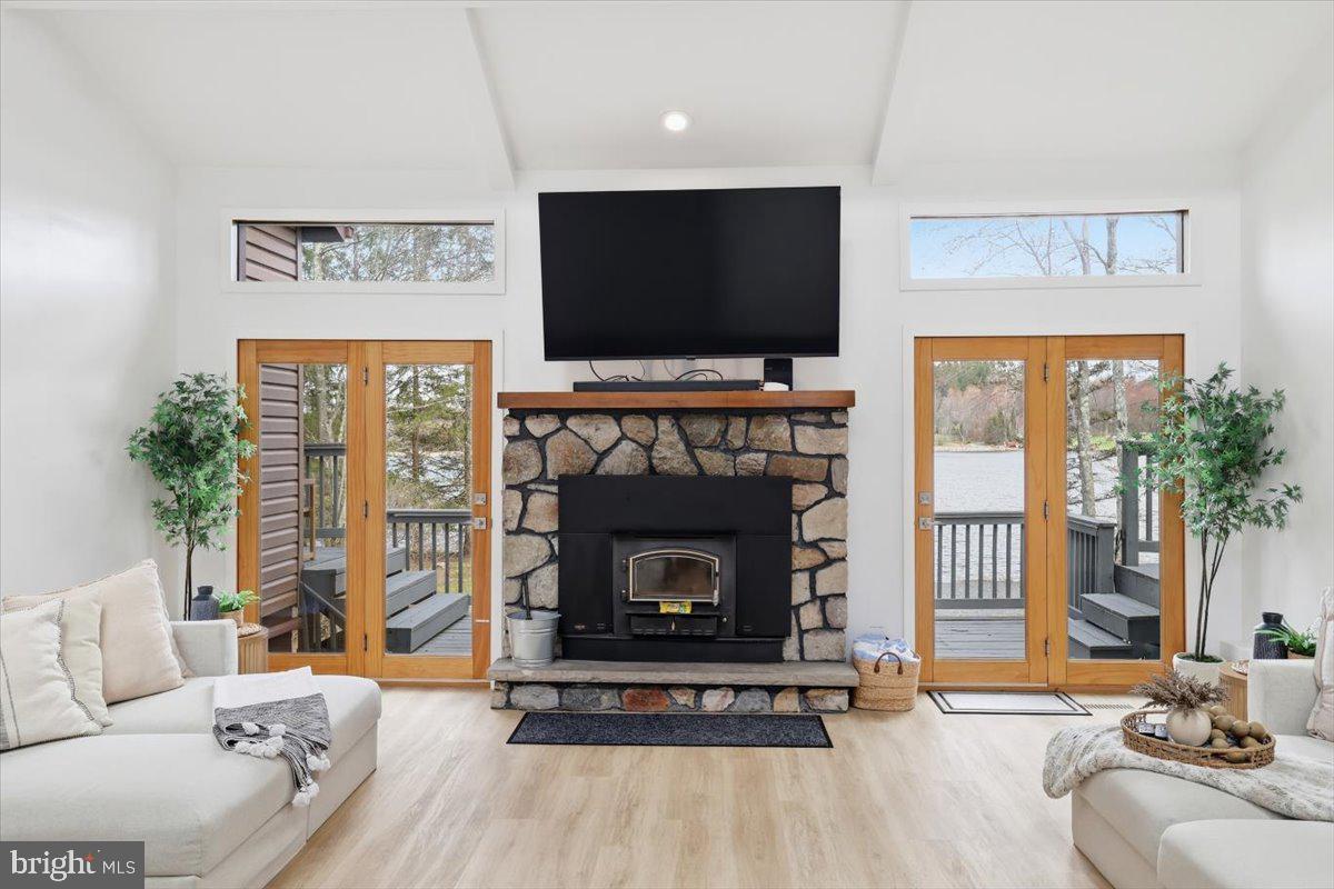 128 Lidio Road Blakeslee, PA 18610 - Photo 7 of 63 a living room with furniture a flat screen tv and a fireplace