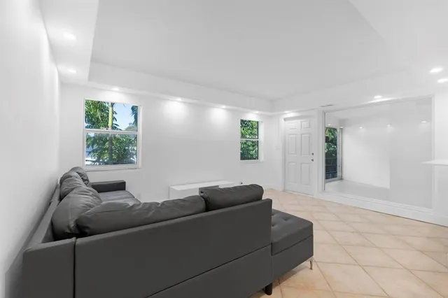 a living room with furniture and kitchen view