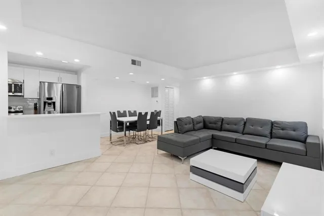 a large white bed in a white room