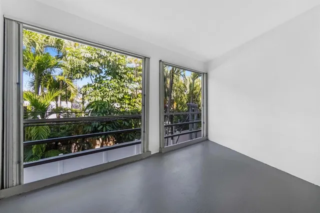 an aerial view of residential houses with yard