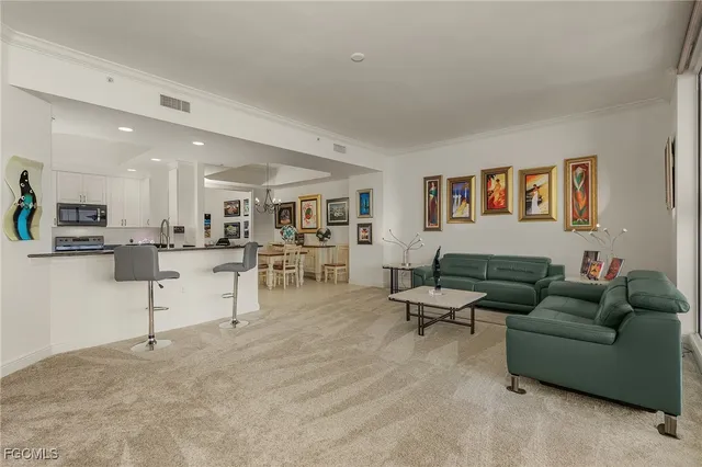 a living room with furniture and view of kitchen