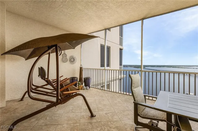 a view of a chairs and table in the balcony