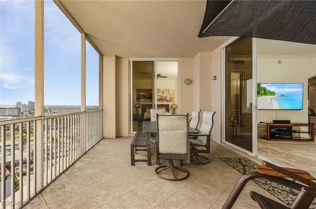 a view of a balcony with chair and tables