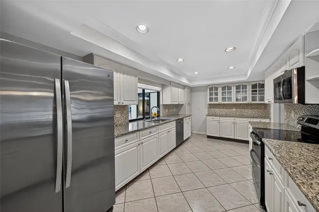 a spacious bedroom with a bed and a chandelier