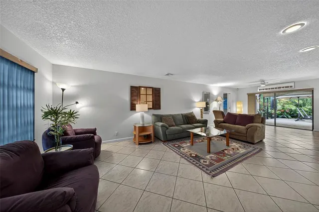 a large kitchen with a stove a sink dishwasher and a microwave oven with white cabinets