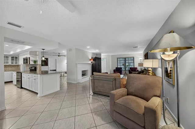a living room with furniture a clock and a large window