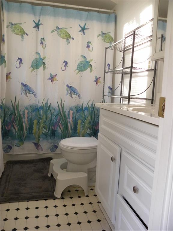 549 State Street Baden, PA 15005 - Photo 16 of 21 a bathroom with a toilet and a shower curtain
