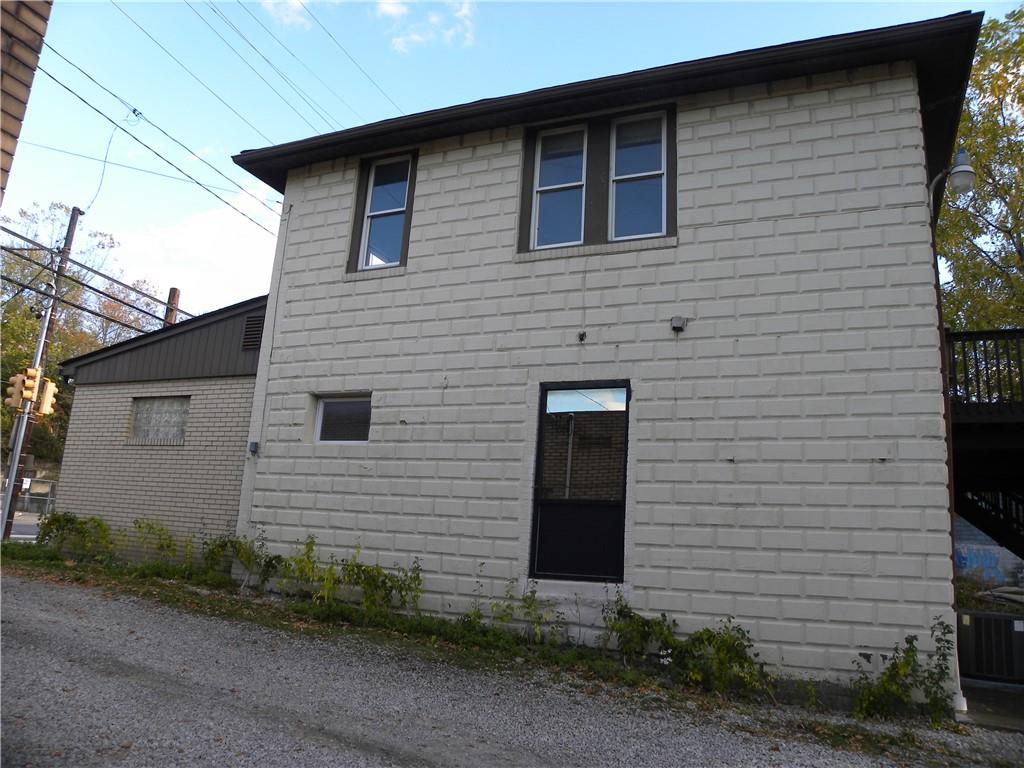 549 State Street Baden, PA 15005 - Photo 19 of 21 a brick house with a yard and garage