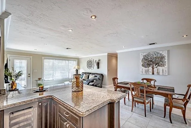 a view of kitchen island a sink wooden floor and living room