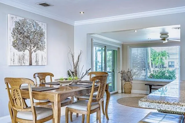 a dining room with furniture and a window