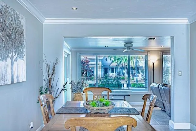 a view of a dining room with furniture a chandelier and wooden floor