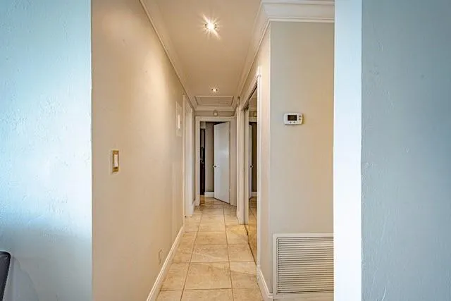 a view of a hallway with wooden shelves