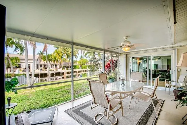a dining room with furniture and a floor to ceiling window
