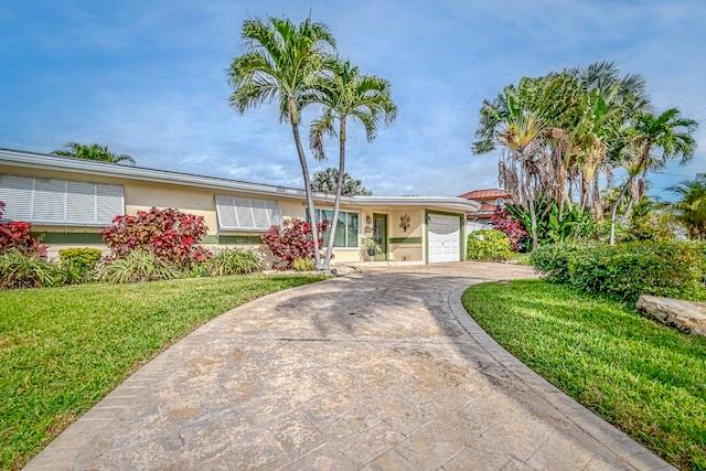1131 Southeast 5th Avenue Pompano Beach, FL 33060 - Photo 3 of 39 front view of a house with a yard and potted plants