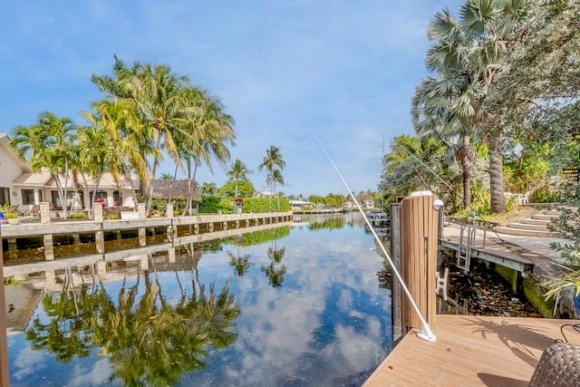 1131 Southeast 5th Avenue Pompano Beach, FL 33060 - Photo 36 of 39 a view of a swimming pool with a lawn chairs and potted plants