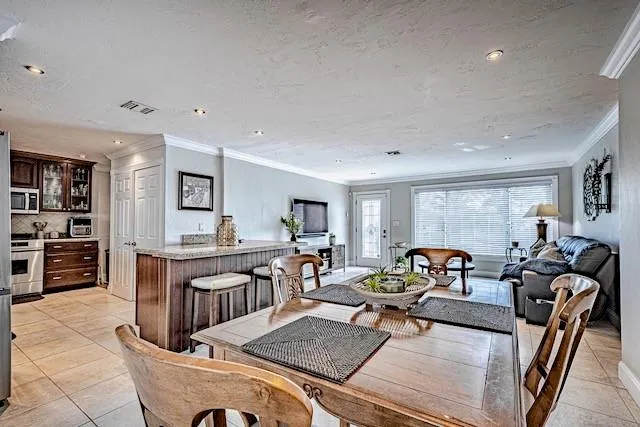 a living room with furniture a large window and a table