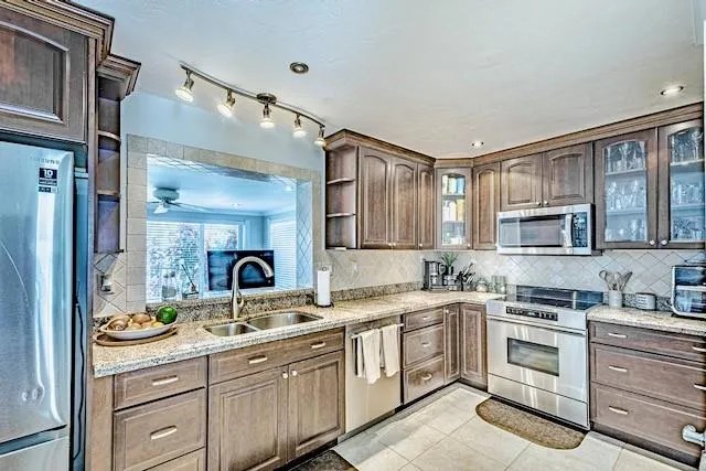 a kitchen with a sink stove and cabinets