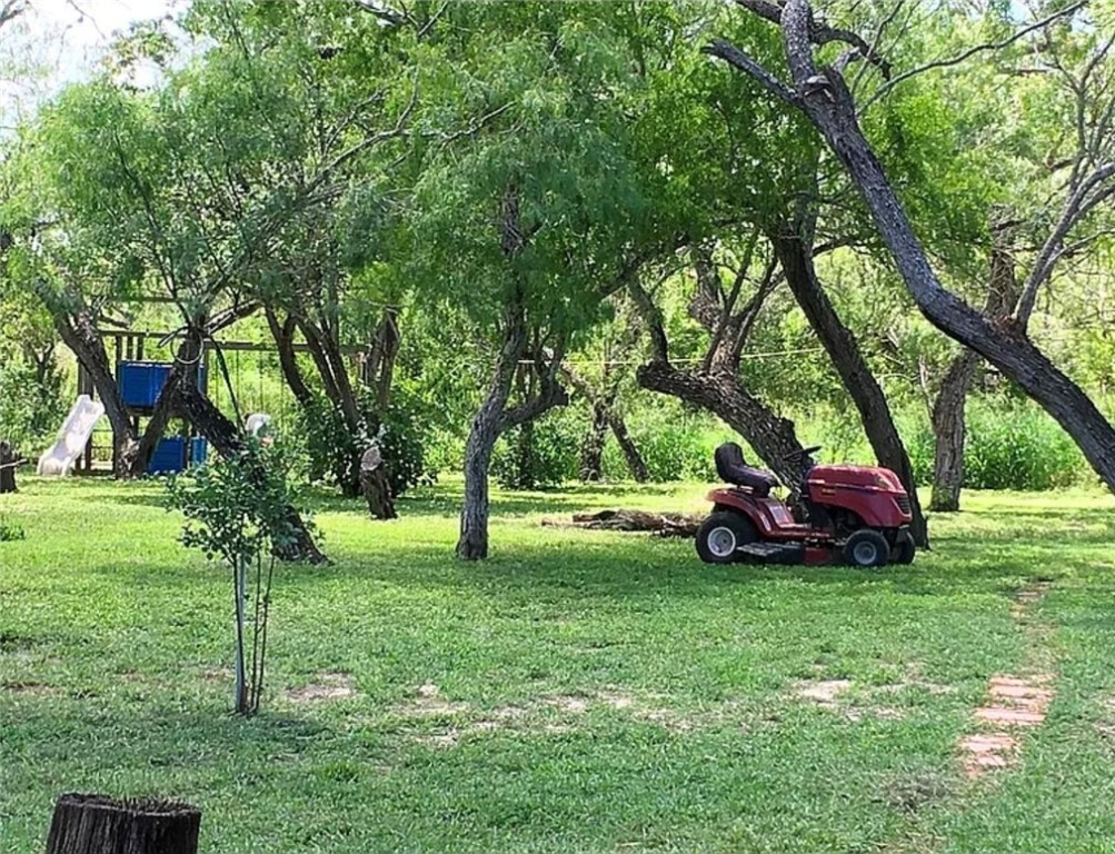 49 Bayview Drive Mathis, TX 78368 - Photo 19 of 20 a view of a park with trees and a wooden fence