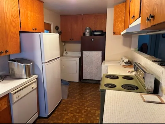 a kitchen with a refrigerator and a stove