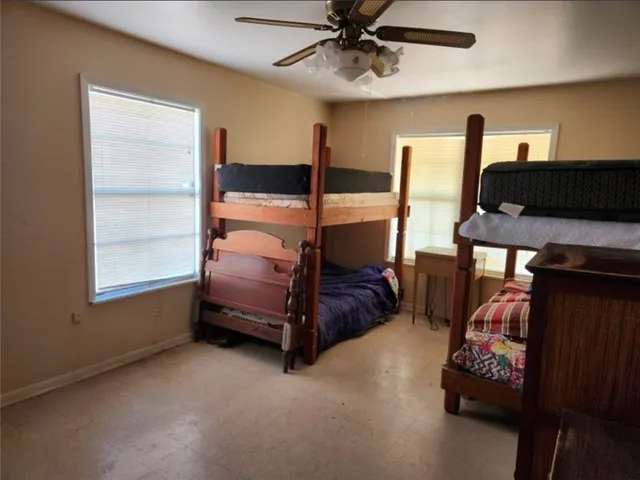 a bedroom with furniture and a flat tv screen
