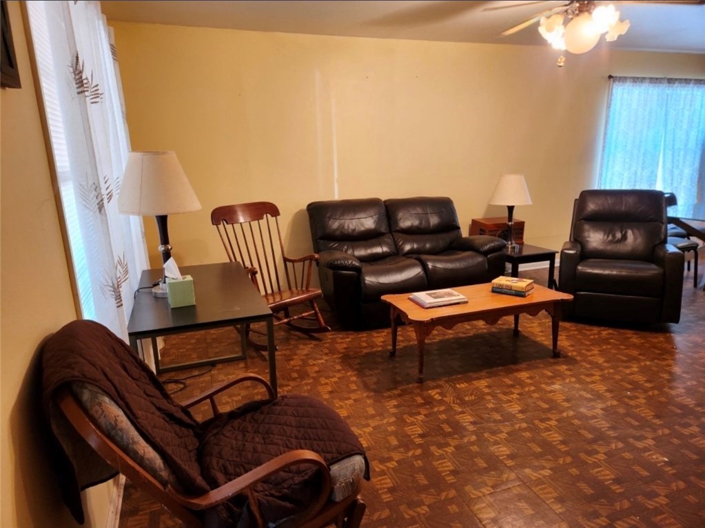 49 Bayview Drive Mathis, TX 78368 - Photo 10 of 20 a living room with furniture a rug and a piano