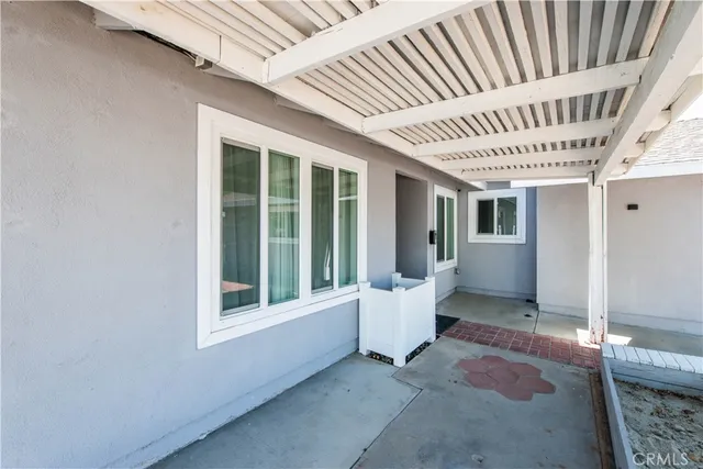 a view of a porch with furniture and front door