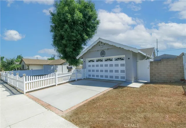 a view of a house with a garage and yard
