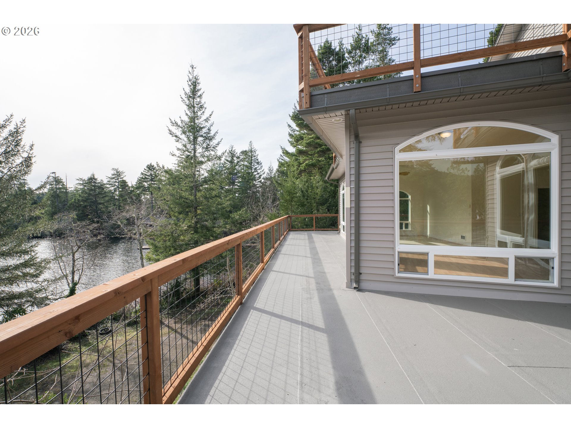 5816 Martin Road Florence, OR 97439 - Photo 32 of 47 a view of a balcony with wooden floor and fence