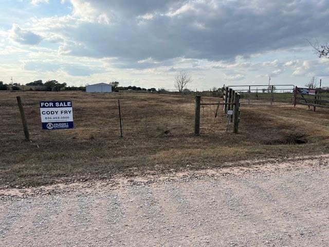 8573 Loop Road Bellville, TX 77418 - Photo 3 of 10 a view of a dry yard with wooden fence