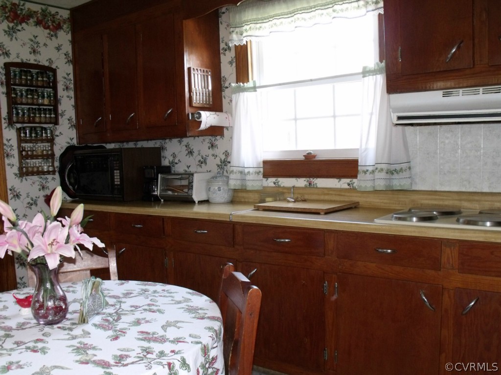 612 Columbia Road Petersburg, VA 23803 - Photo 11 of 21 a kitchen with a stove a sink and a microwave