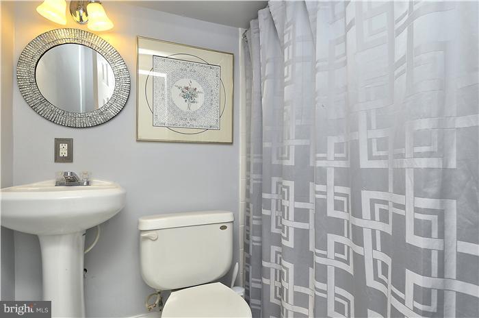 310 West Glebe Road Alexandria, VA 22305 - Photo 18 of 22 a bathroom with a toilet a sink and a mirror