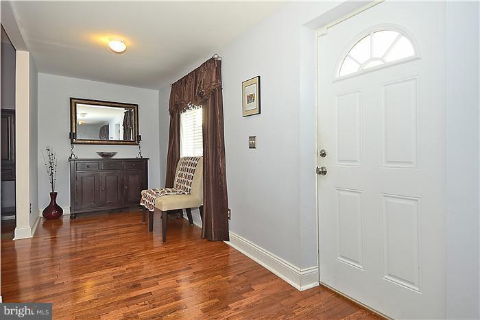 310 West Glebe Road Alexandria, VA 22305 - Photo 21 of 22 a view of a livingroom with furniture a fireplace wooden floor and windows