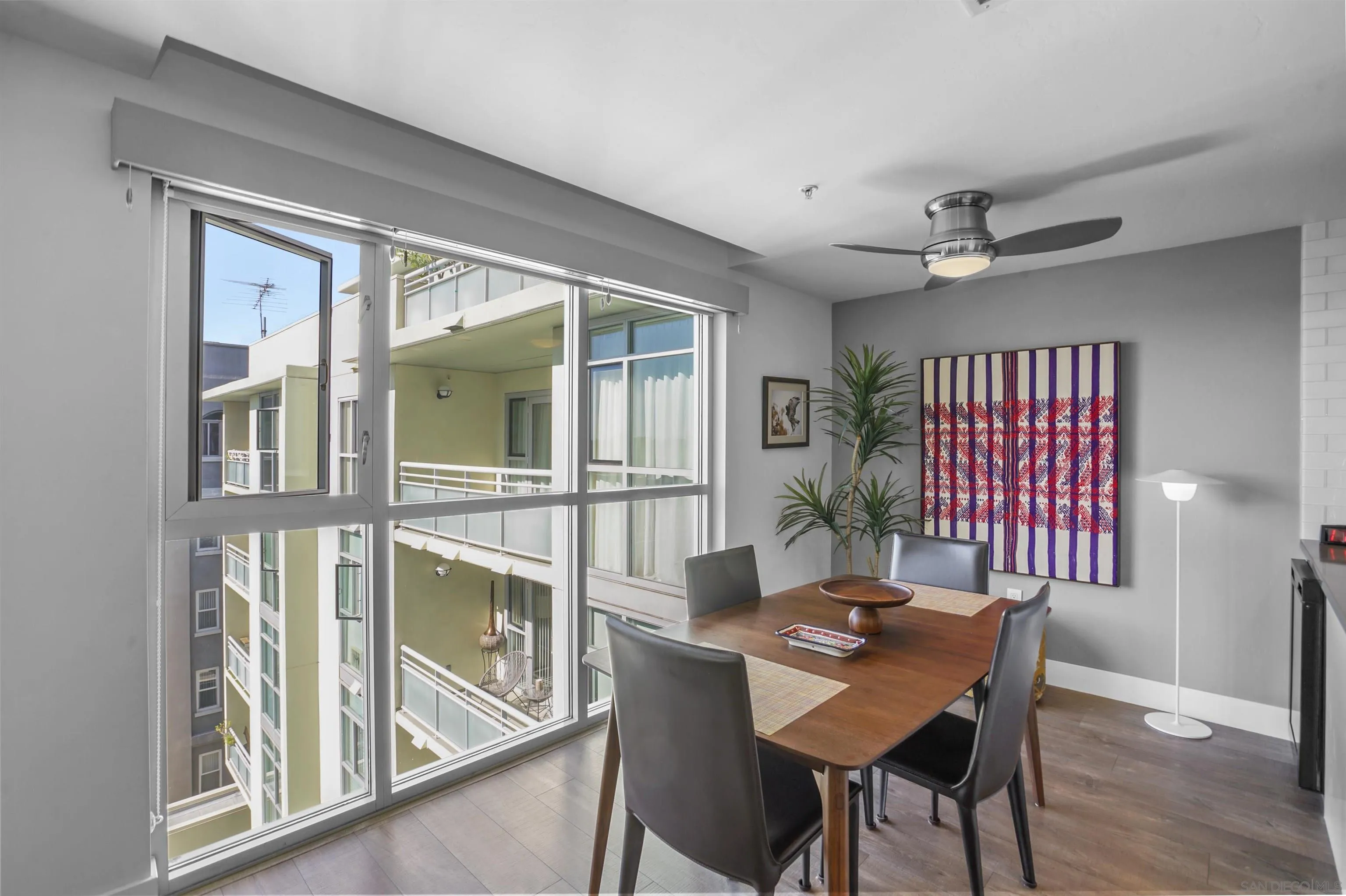 3812 Park Boulevard, Unit 503 San Diego, CA 92103 - Photo 12 of 27 a view of a dining room with furniture window and wooden floor