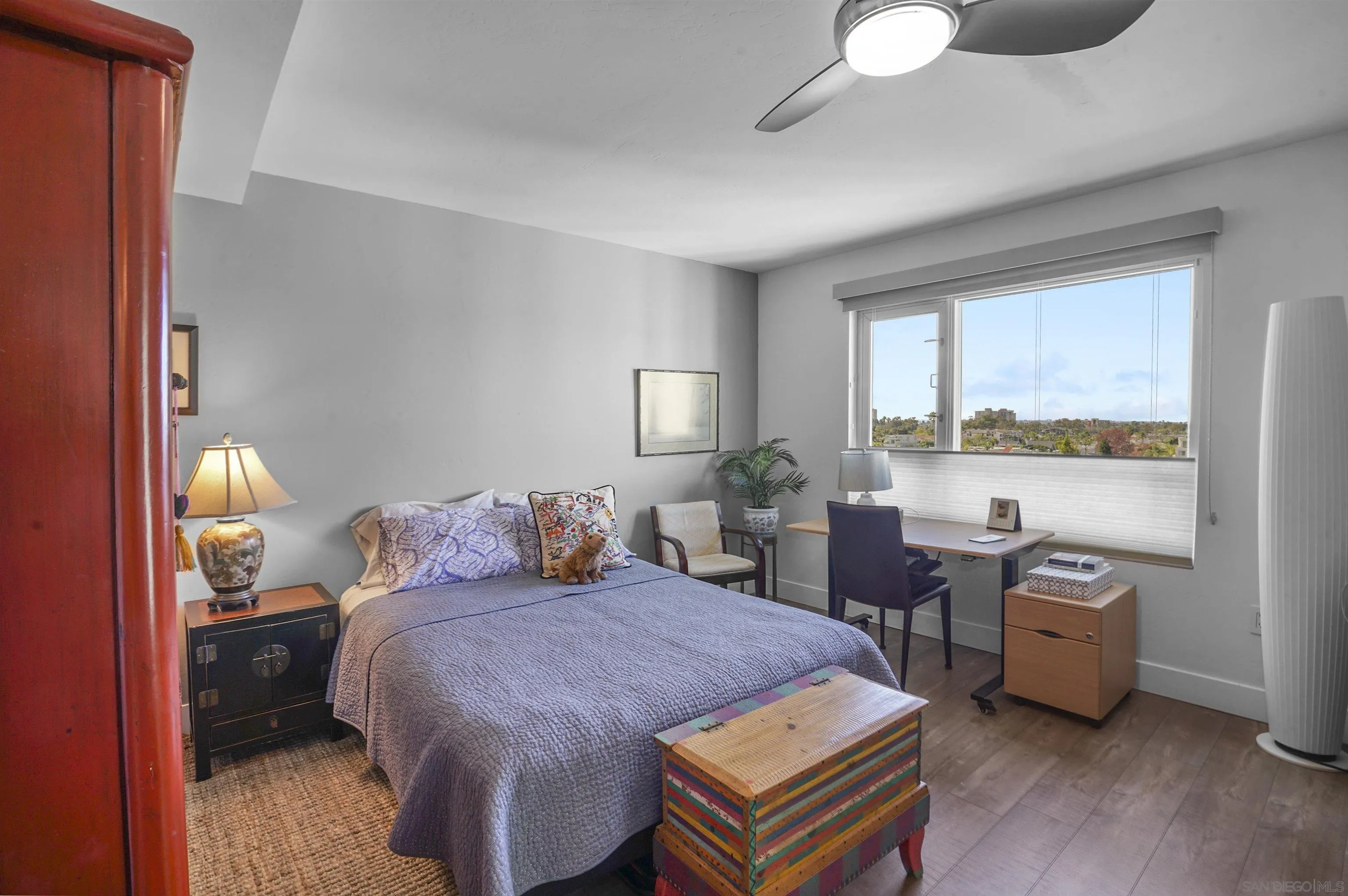 3812 Park Boulevard, Unit 503 San Diego, CA 92103 - Photo 14 of 27 a bedroom with a bed a table and a dresser next to a window